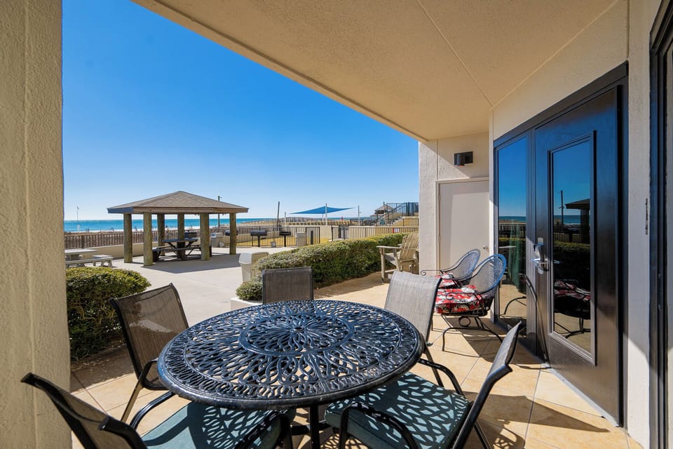 Warm sunlight fills your patio where you lounge near the gulf and watch waves shimmer on the shore