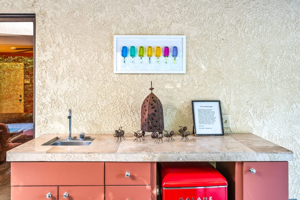 Outdoor wet bar with mini-fridge.  