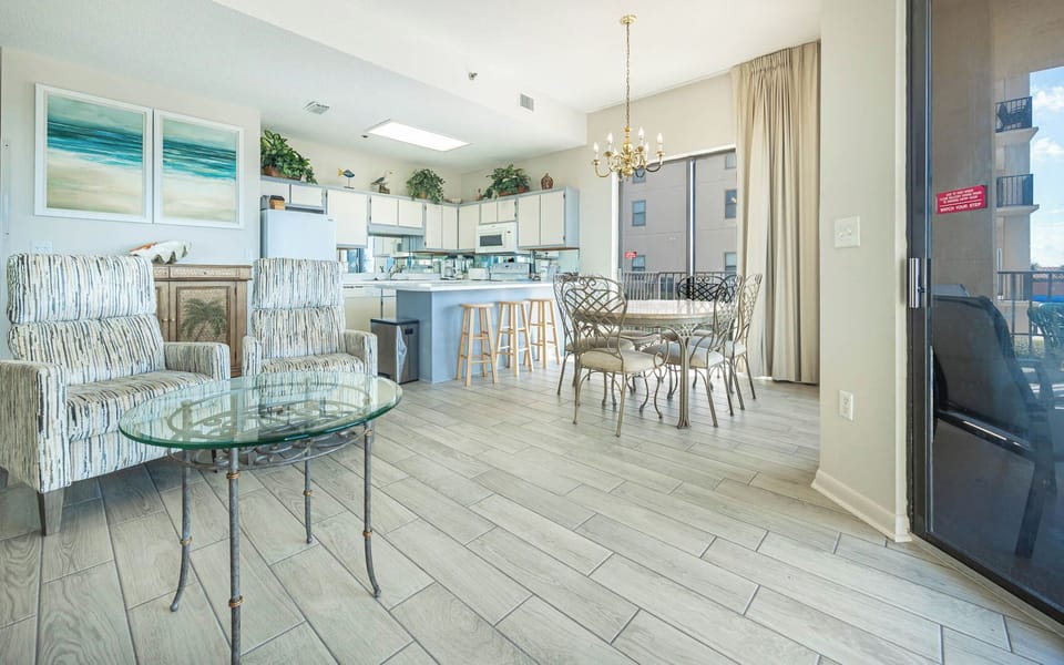 Relax in the inviting living space with comfortable seating, a stylish dining area, and a view of the kitchen