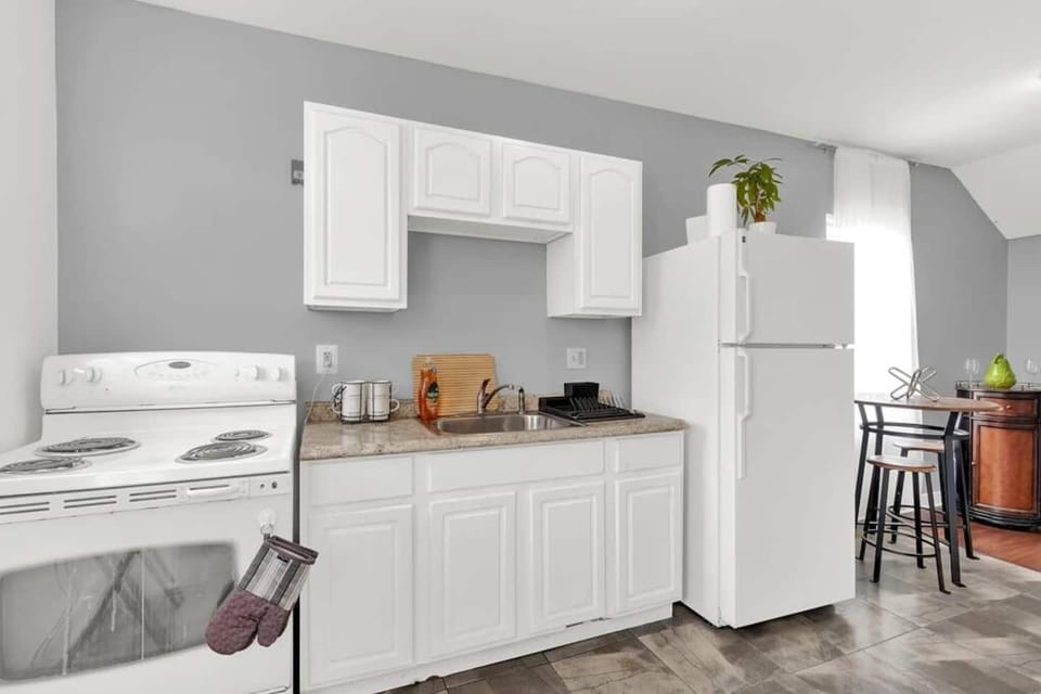 Fully stocked kitchen with fridge, freezer oven, stove and pantry area.