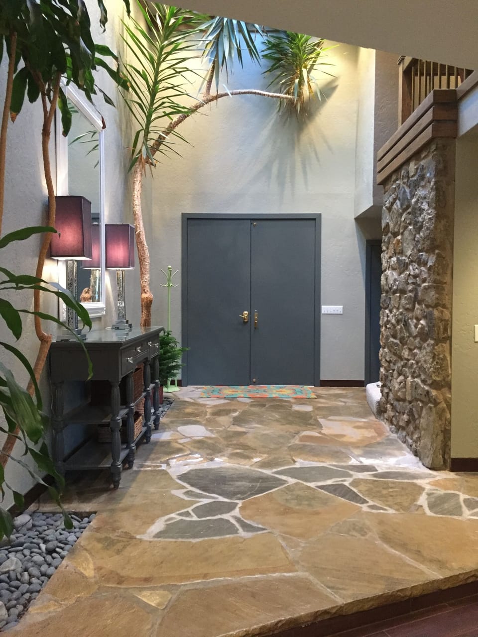 Entry way with live trees and skylights.
