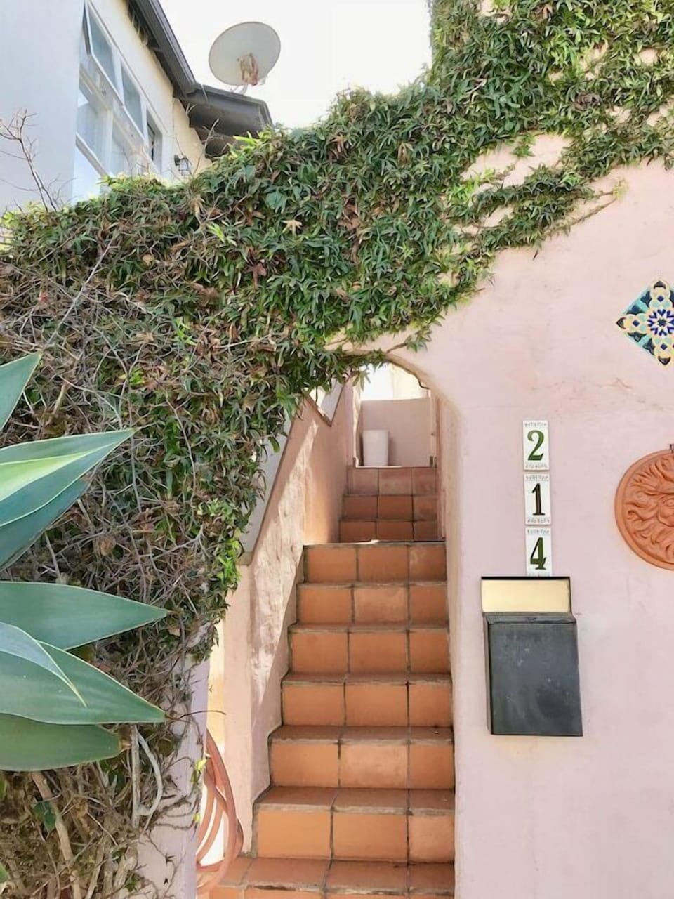 Walk through the archway and up the stairs to the front door