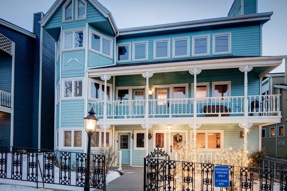 Exterior: Charming Victorian-style façade with vibrant colors, inviting ambiance, and mountain views!