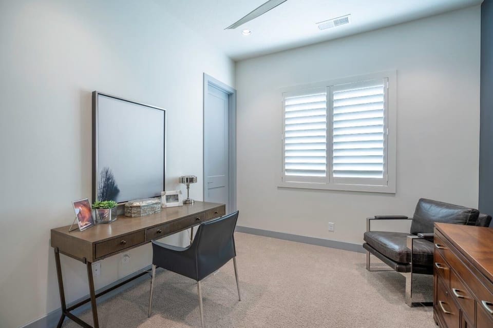 Den off of kitchen with convenient workspace