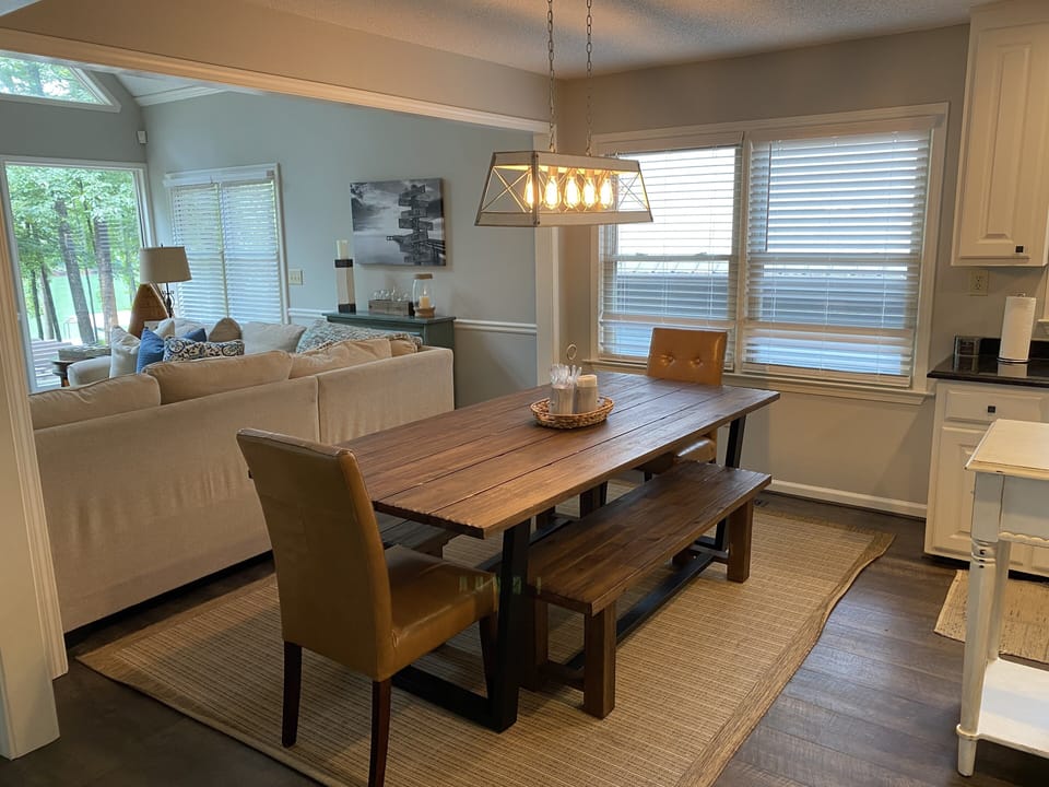 Updated kitchen with LVP flooring, new stainless steel appliances and farm table