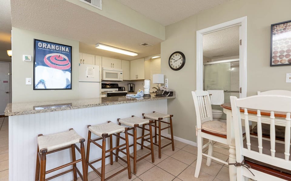 This kitchen features granite countertops, stainless appliances, and a cozy dining area, perfect for enjoying meals together