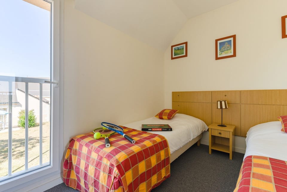 The third bedroom features 2 single beds.