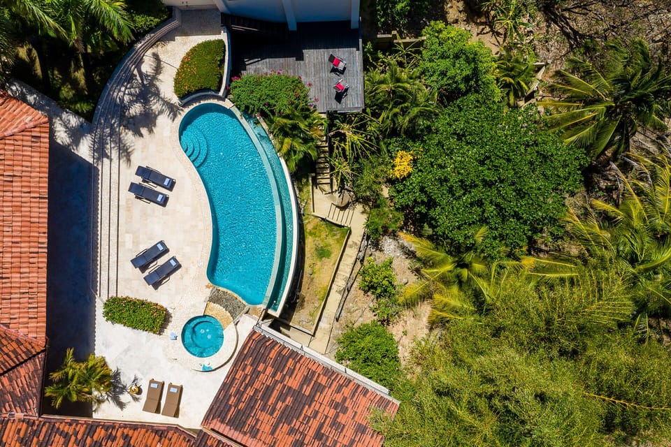 brids-eye view on the pool and beach-access staircase (sub-pool terrace visible)