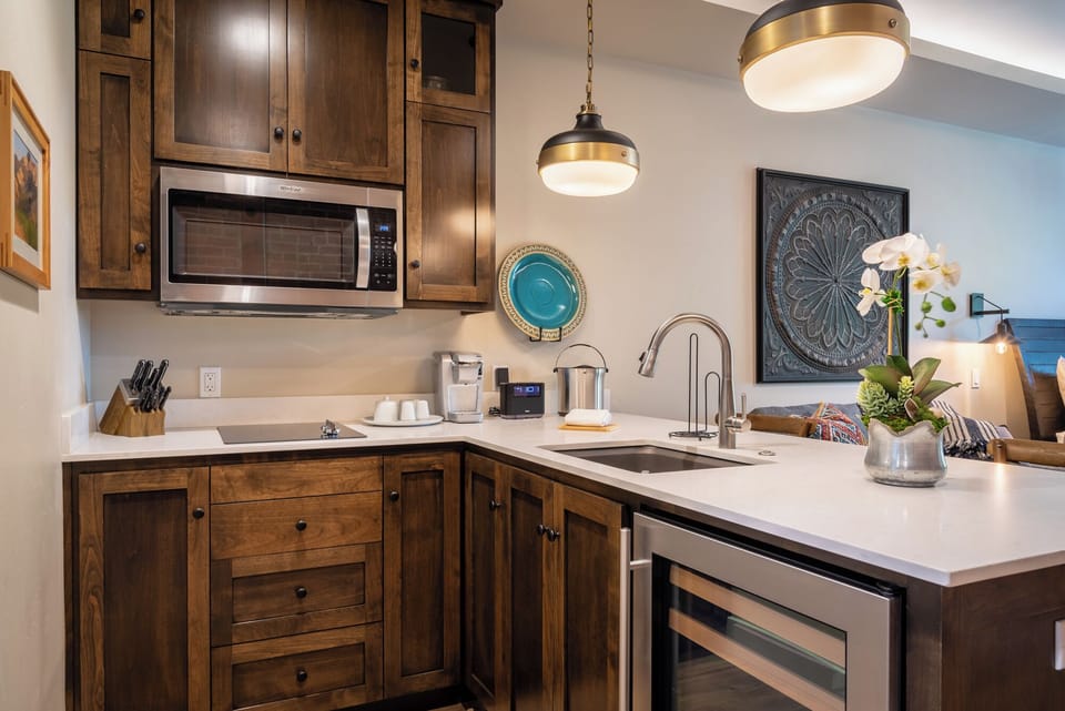 Quartz counters keep prep moving beside the double sink