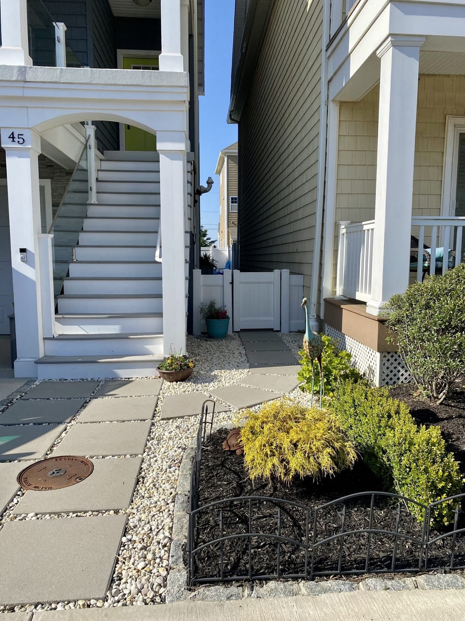 Entrance is NOT up the stairs, entrance is through the side gate shown here. 