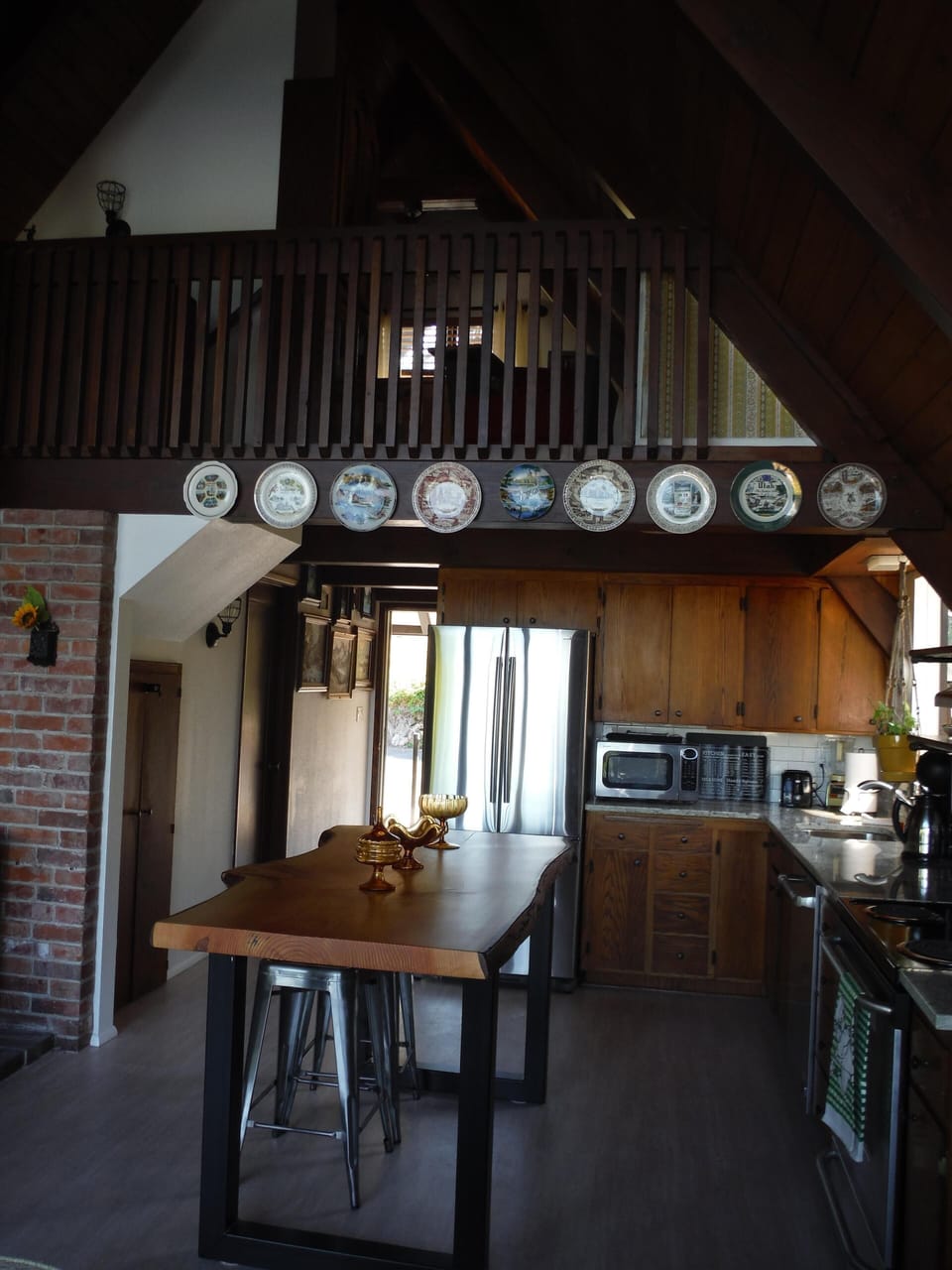 Facing front door and loft above from dining area 