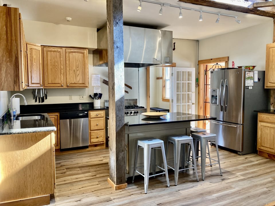 First floor stainless kitchen with granite island and 5 stools.