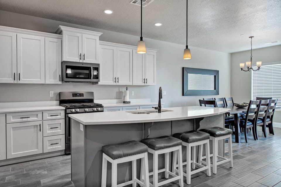 Seating for 12 in the kitchen area + more on the patio table outside.