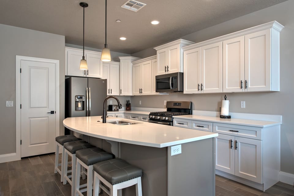 The gourmet kitchen features designer cabinets & delux white quartz countertops.