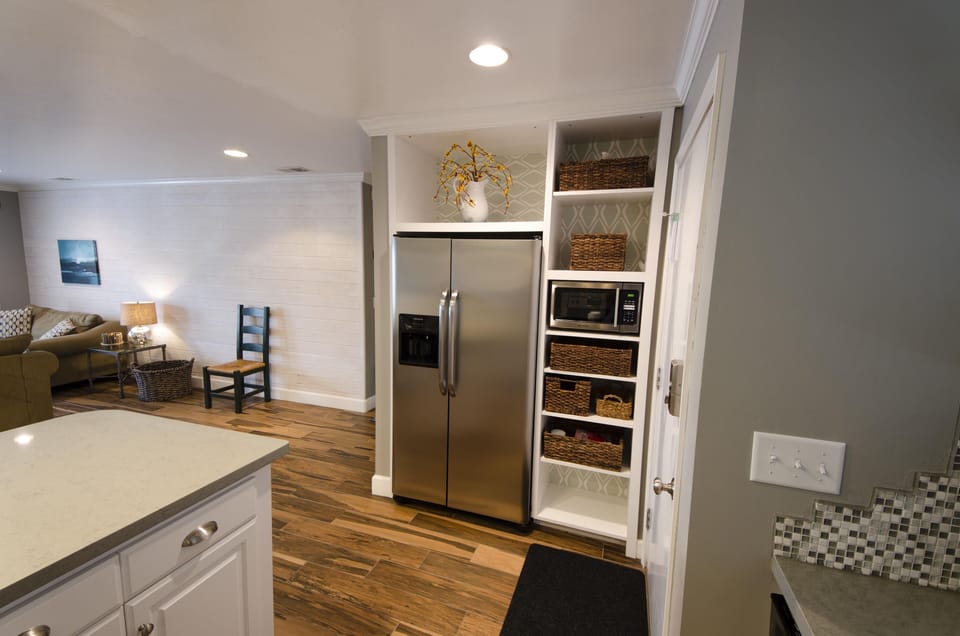 Side-by-side stainless Frigidaire refrigerator.  Stainless steel microwave.