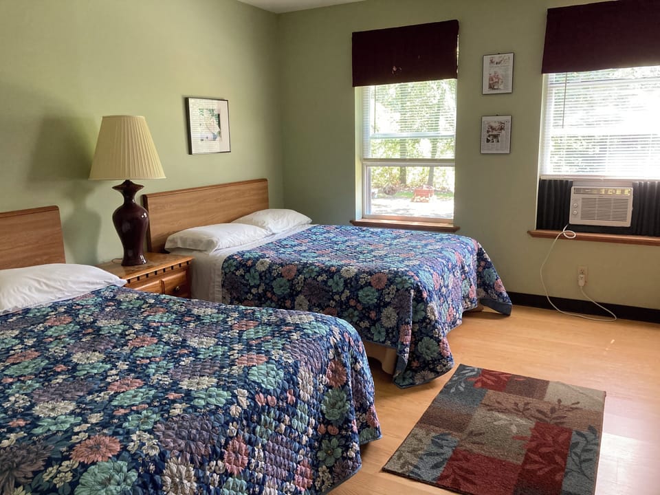 First floor bedroom with two double beds.