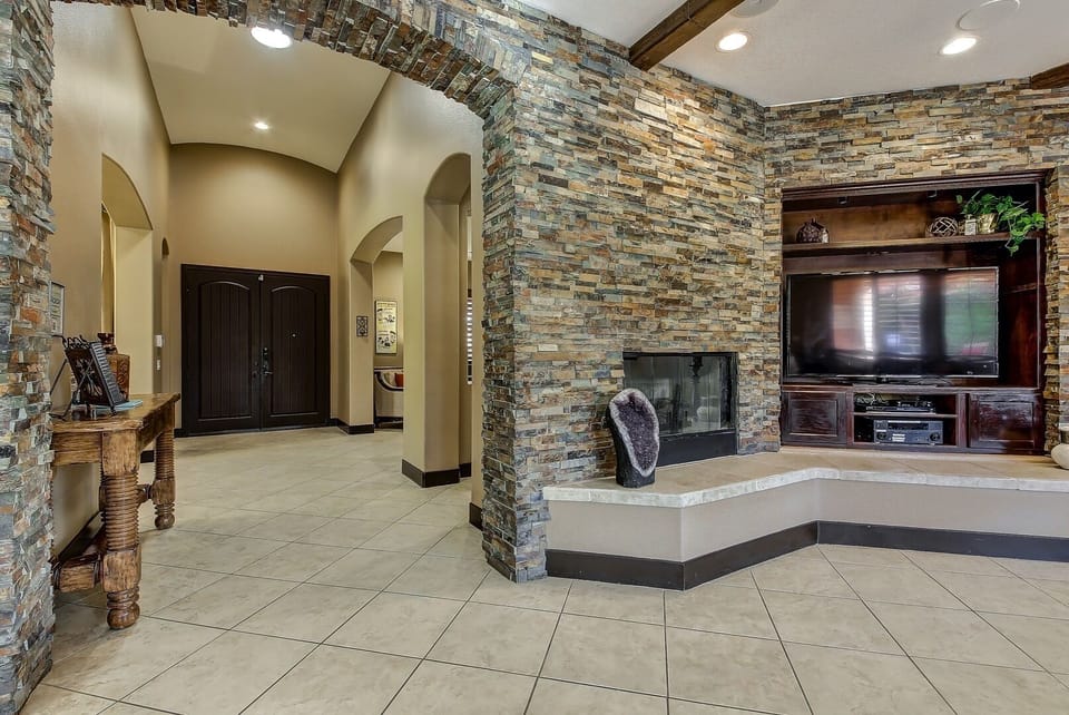 Custom stone walls and entryway with 10 ft ceilings throughout the house.