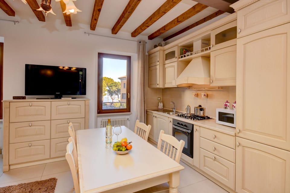 Open dining room with dining table, comfortable sofa bed and smart TV