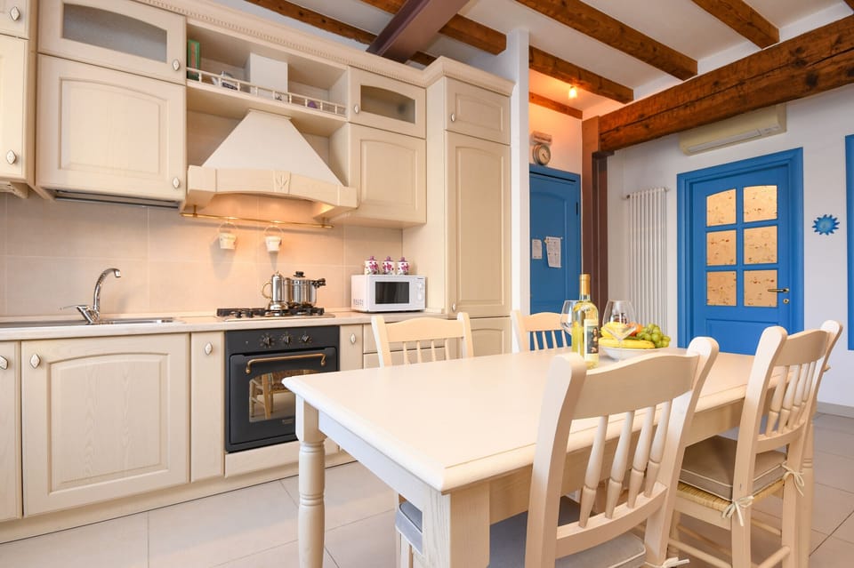 Kitchen equipped with fridge, microwave and dishwasher