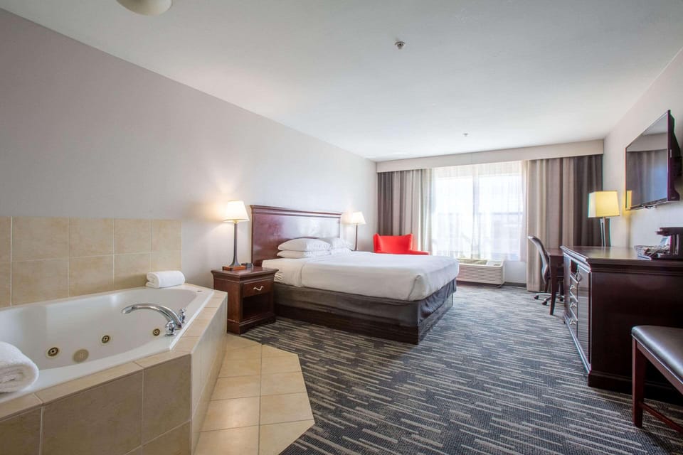 Suite, 1 King Bed, Non Smoking, Jetted Tub | Desk, laptop workspace, blackout drapes, iron/ironing board