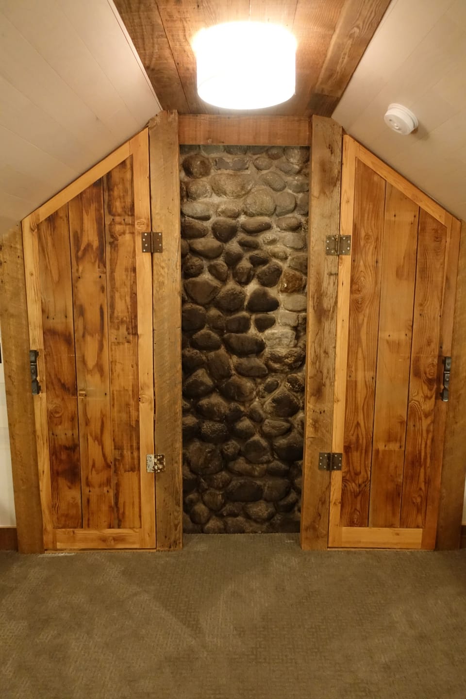 Bunk room doors closed revealing fireplace chimney