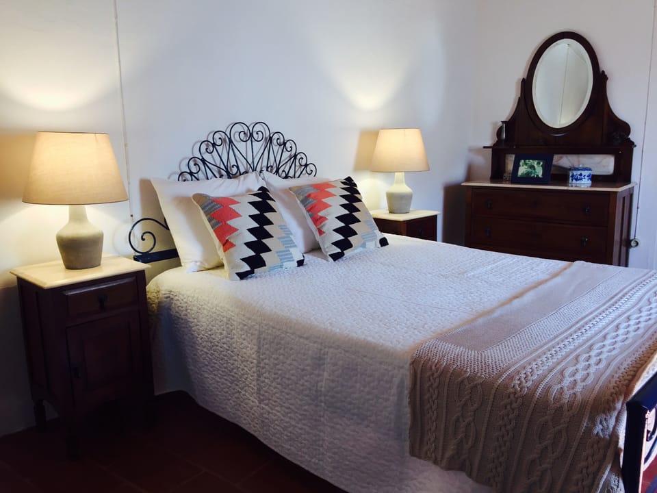 Room 2 has one double bed and a dresser.