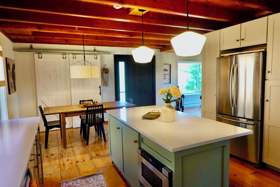 Island with Kitchen drawer microwave, quartz countertops, refrigerator