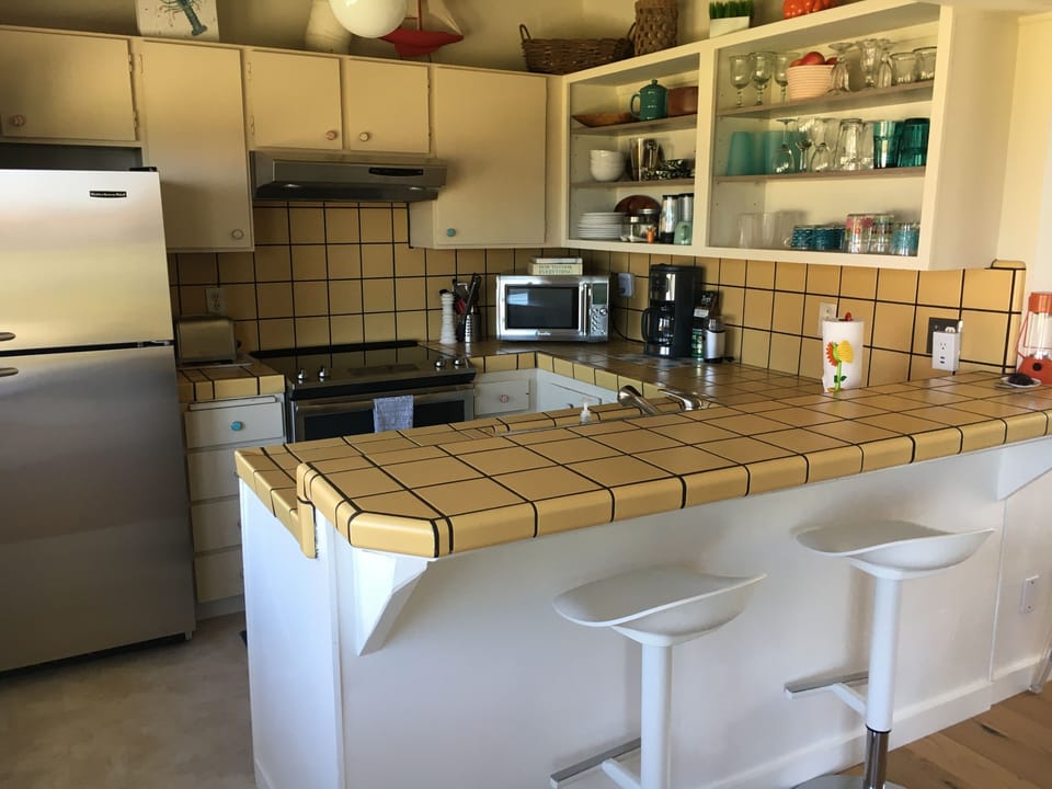sunny and clean kitchen with ocean view and breezes