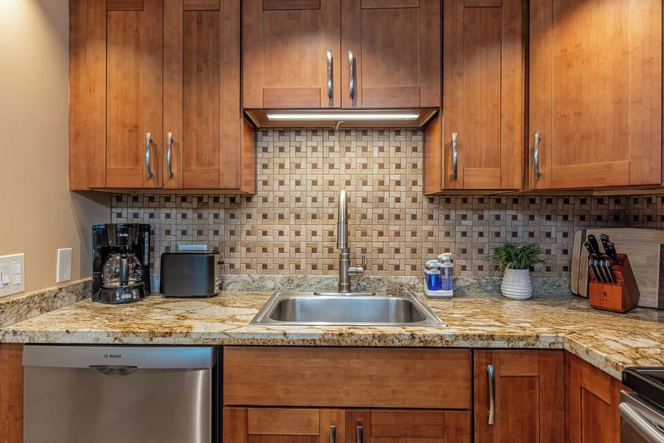 Your well-equipped kitchen features warm wood cabinetry, granite countertops, and everything you need to prepare meals during your stay, including a coffee maker, dishwasher, and stainless steel appliances.