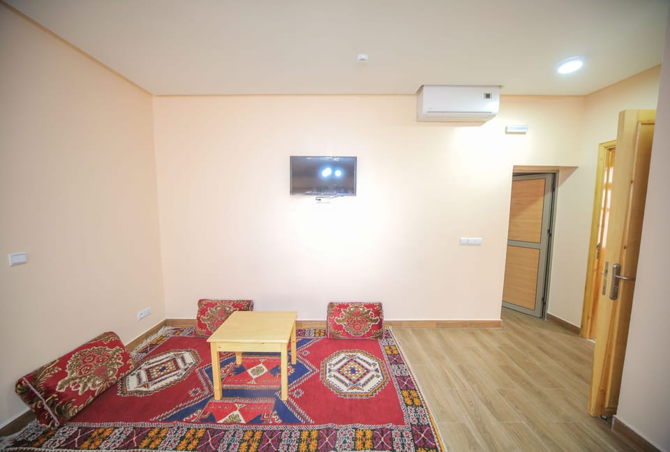 Junior Suite, 1 King Bed, Non Smoking | Living room | Flat-screen TV