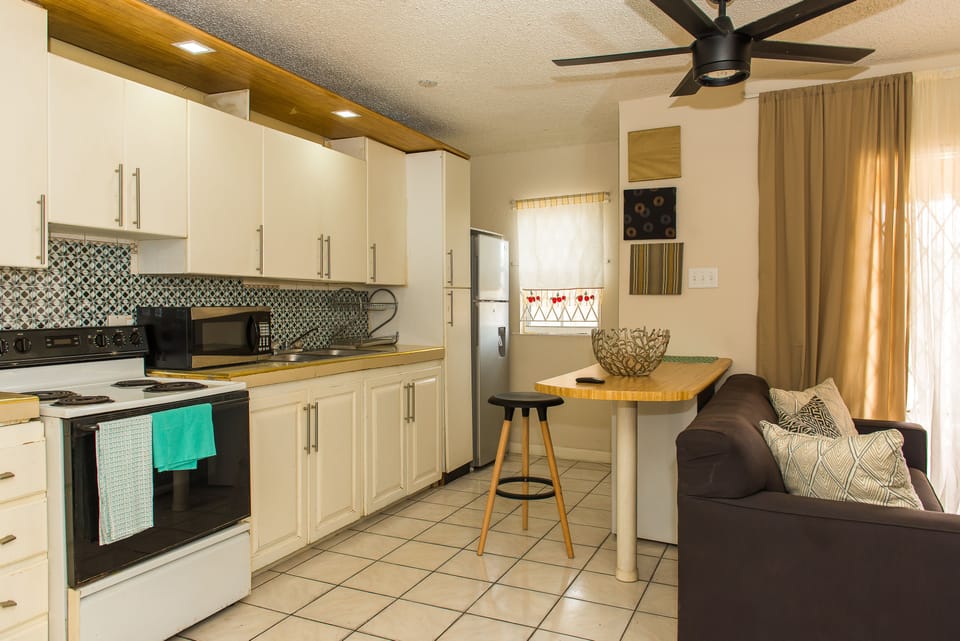 Business Apartment, Pool View | Living area | 50-inch flat-screen TV with cable channels, TV, DVD player