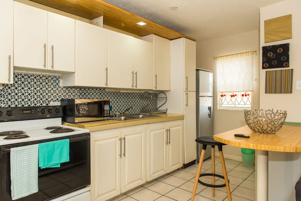 Business Apartment, Pool View | Private kitchen | Full-size fridge, microwave, oven, stovetop