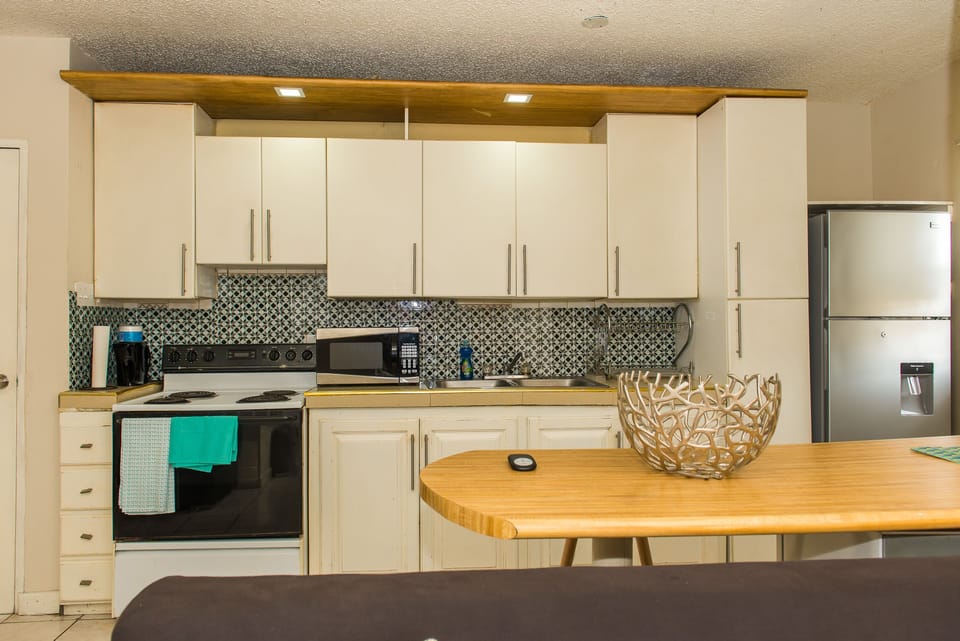 Business Apartment, Pool View | Private kitchen | Full-size fridge, microwave, oven, stovetop