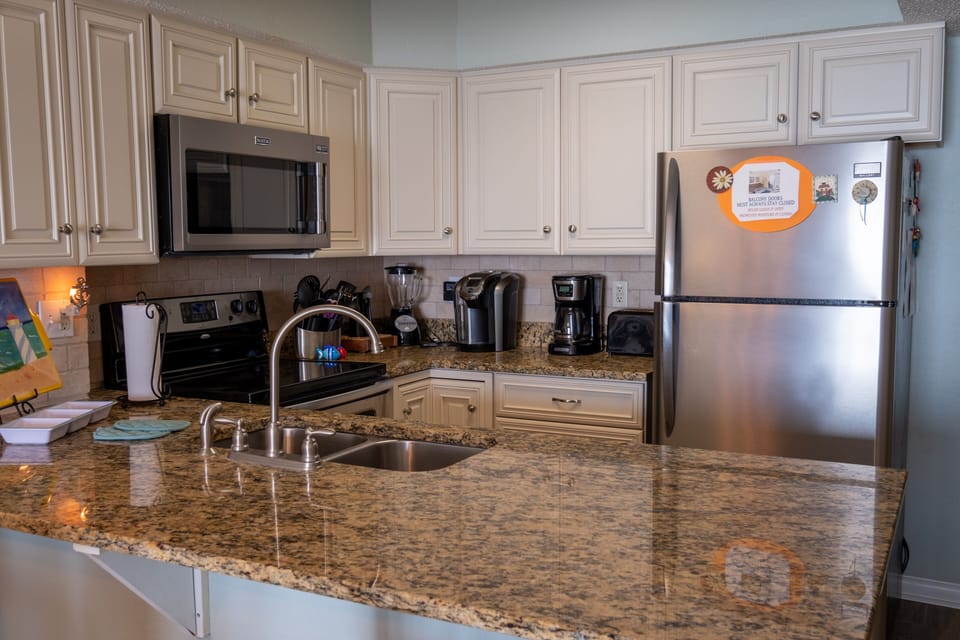 Kitchen with stainless appliances and granite countertop