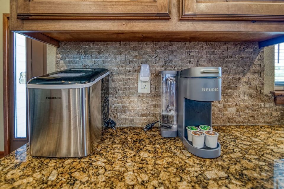 Kitchen with 2 coffee pots with a portable ice maker.