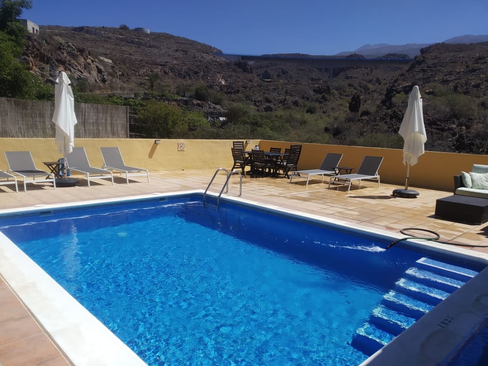 newly refurbed pool area with steps into pool, new sofas and sunbeds!