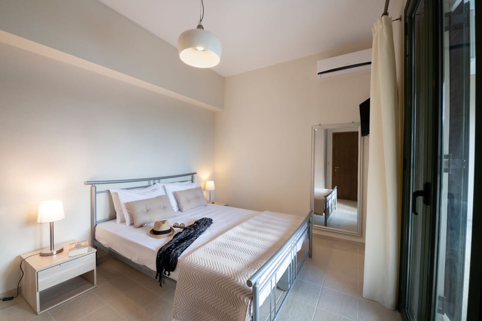 Bedroom of the second apartment with direct access to the pool and the garden!
