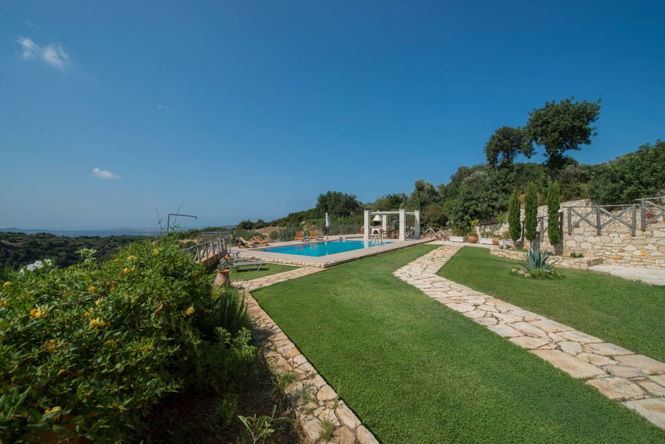 Fenced garden area with trees, grass and flowers! 