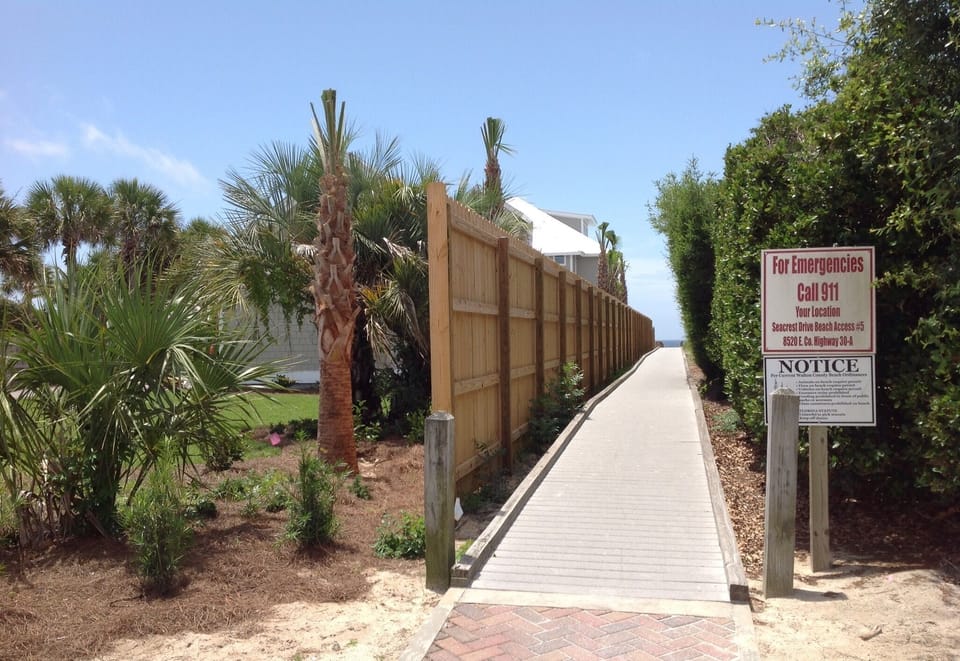Just 65 footsteps from driveway is beach walkover, right across from the house.