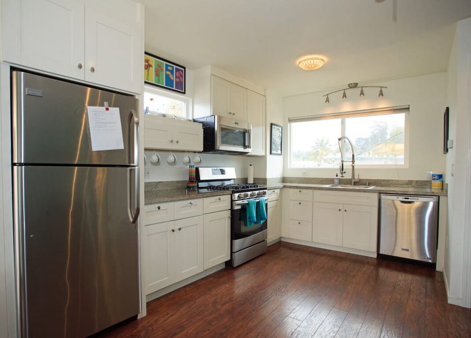 Kitchen with dishwasher, oven, stove, fridge, garbage disposal