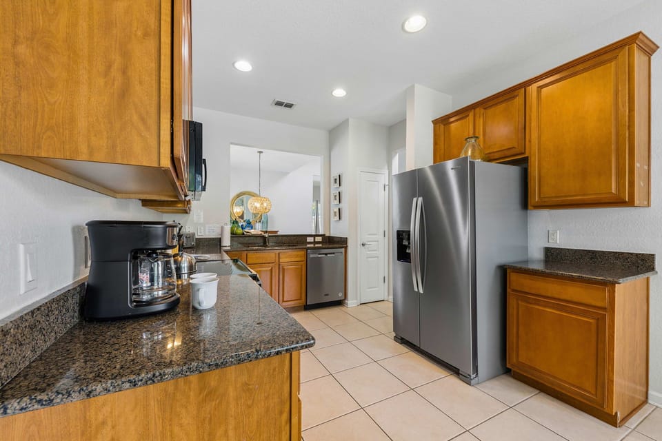 Charming kitchen of the home in Kissimmee, Florida - Fully Equipped  kitchen with sleek, stainless-steel appliances - Plenty of storage space available to keep counters organized