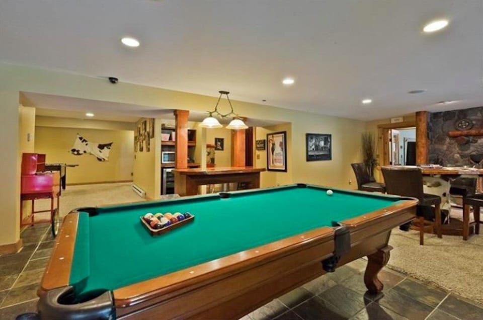 Basement with pool table, custom candy counter, card table, fireplace, foosball