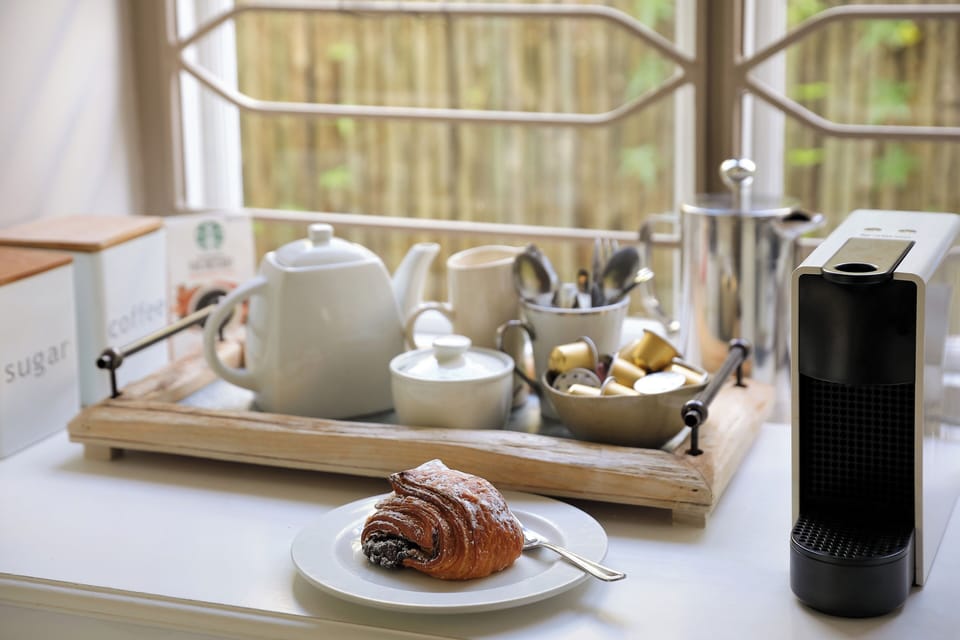 Adjacent to the kitchen is a separate tea/coffee station with plenty of storage