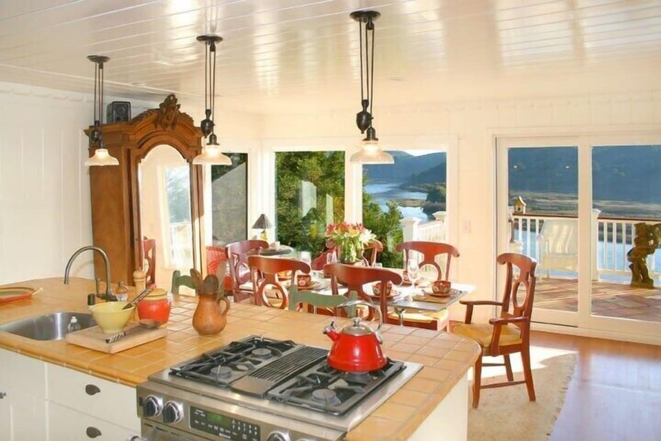 View from kitchen looking out in the morning towards the dining room. The colors change with the seasons which is fascinating to watch. My favorite time here for colors is January through March when the hills are bright screaming green and the sky and water are a deep luscious blue. 