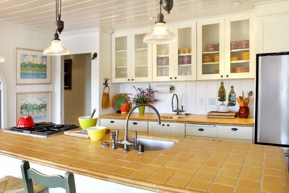 Lots of room to gather round and share in the kitchen with this bar next to the dining room. There is a great selection of Fiesta dishes to mix and match and ample silver wear for a lovely table setting. 