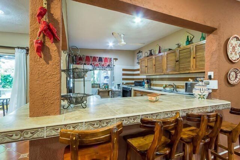 A breakfast bar adjoins the kitchen