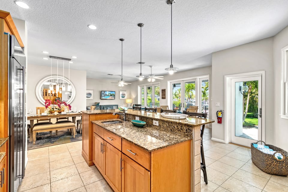 From here, the whole space unfolds—where cooking, conversation, and sunshine blend effortlessly.