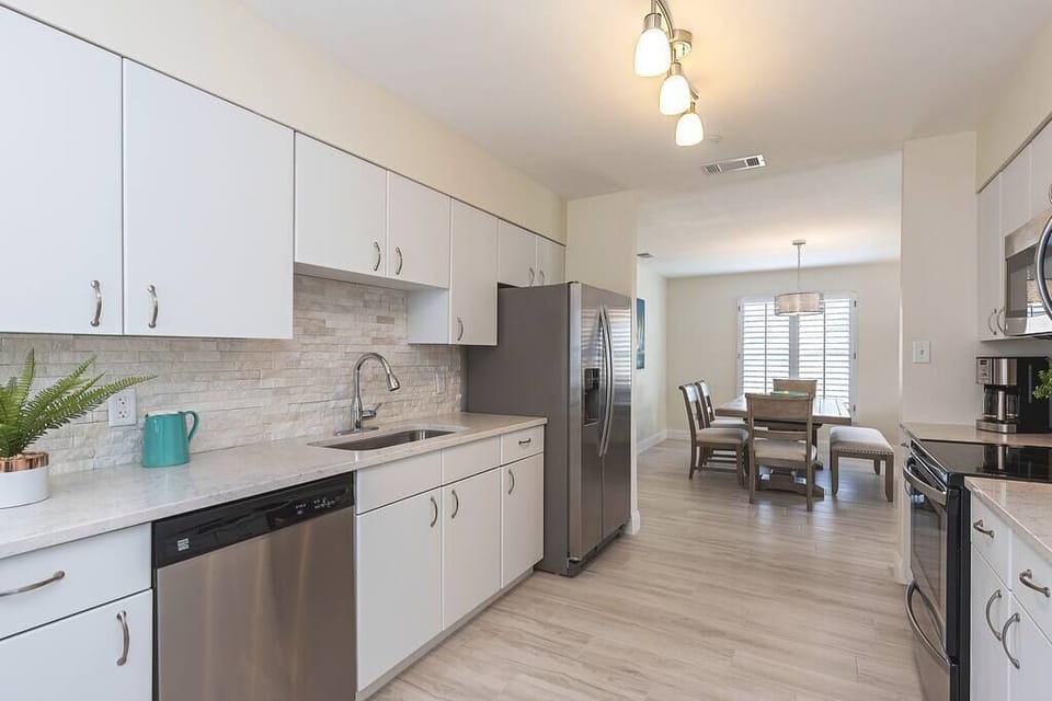 Kitchen w/New Quartz Countertops, Stainless appliances and everything you need to prepare & serve a delicious meal. 