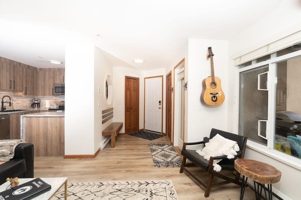 An acoustic guitar is in the suite for you to play