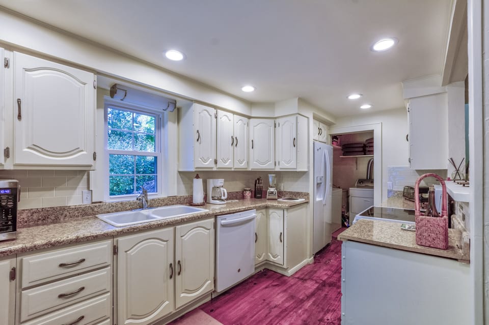Light and bright kitchen with dishwasher, microwave, coffee maker, toaster oven